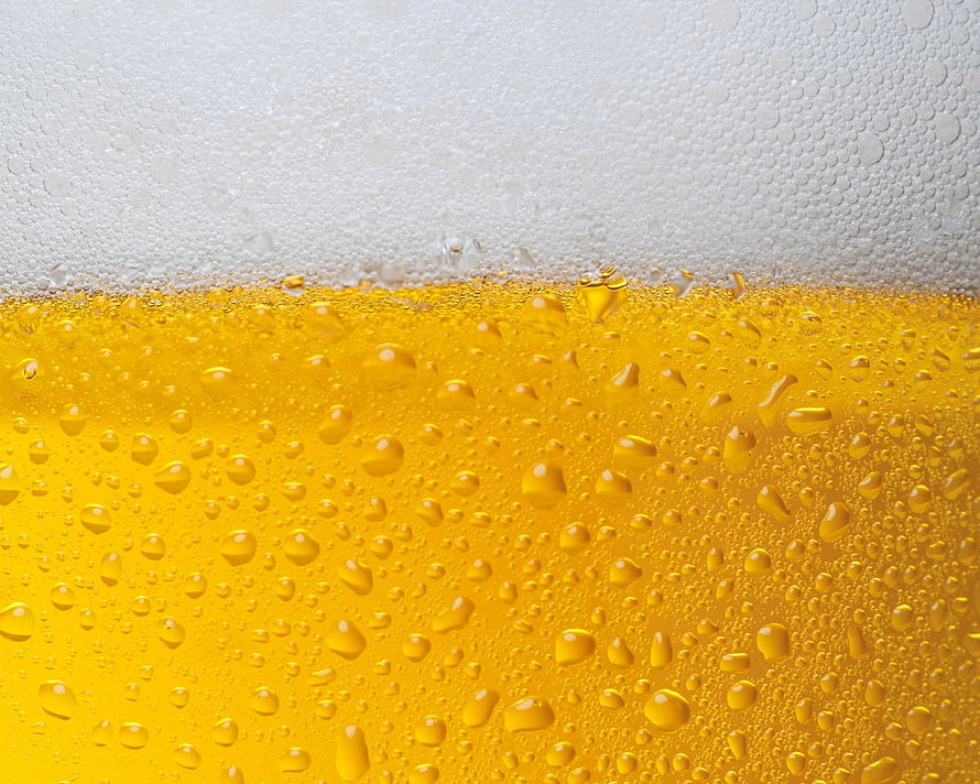 Close-Up of Golden Beer with Frothy White Head and Condensation Droplets HD wallpaper