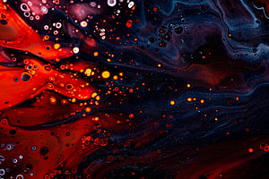 Vibrant abstract fluid art with swirling red and dark blue ink patterns and bubble textures HD wallpaper