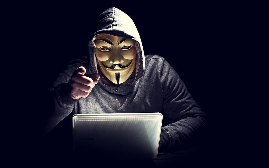 Anonymous Guy Fawkes Mask Hacker Pointing at Laptop in Dark Room HD wallpaper