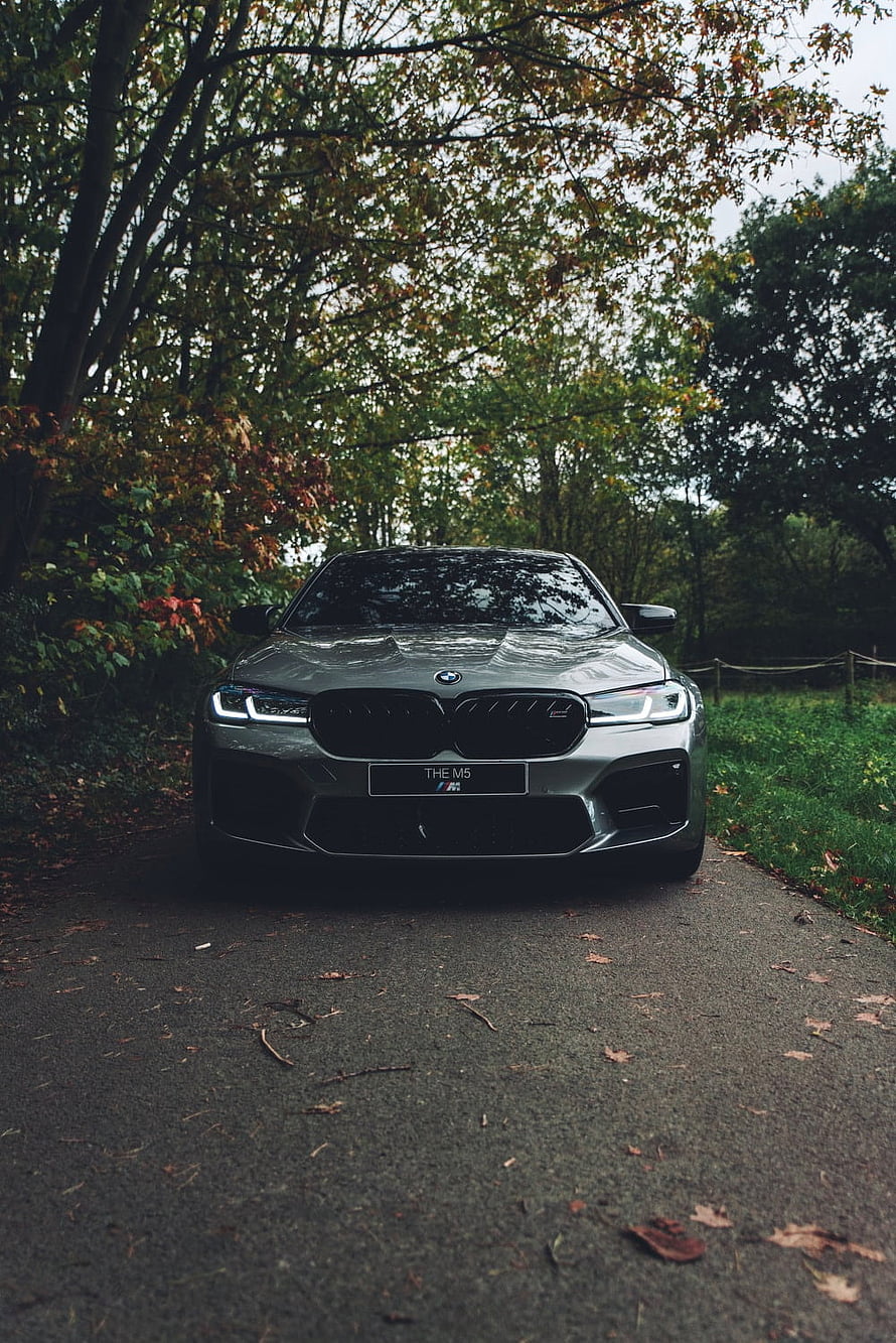 BMW M5 F90 Front View on a Forest Road with Autumn Foliage HD phone wallpaper