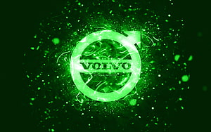 Volvo Green Neon Logo with Glowing Particle Effects on Dark Background HD wallpaper