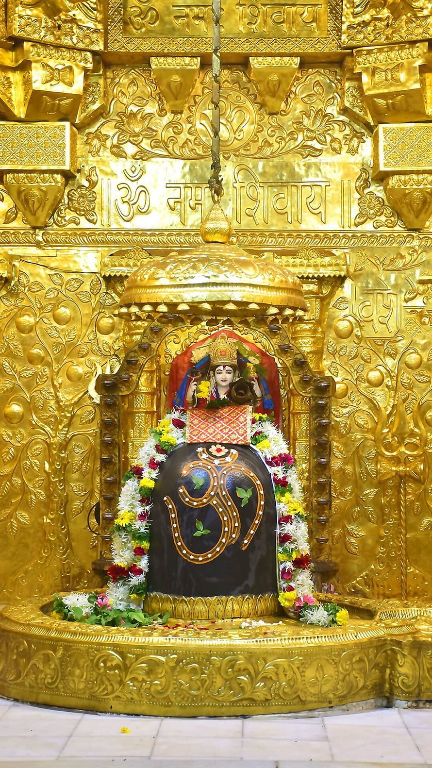 Somnath Mahadev Temple Shiva Lingam with Ornate Gold Carvings and Floral Garlands HD phone wallpaper