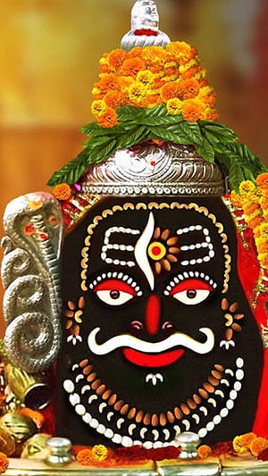 Mahakal Jyotirlinga Face Art with Marigold Garland and Silver Ornament HD phone wallpaper