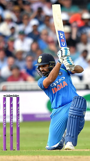 Rohit Sharma in action for India during a cricket match HD phone wallpaper