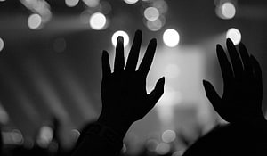 Silhouette of Raised Hands in Black and White Worship Setting HD wallpaper
