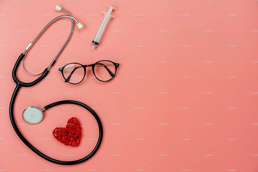 Flat lay of stethoscope, syringe, and glasses with a red heart on a pink background HD wallpaper