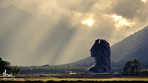 Adiyogi Statue at Isha Yoga Center with Misty Mountains and Golden Sunlight HD wallpaper