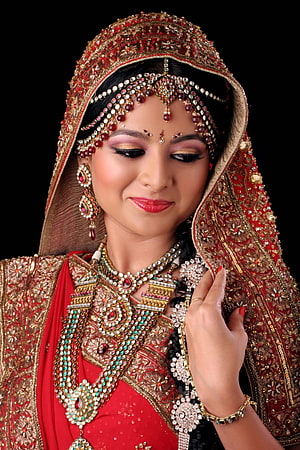 Elegant Indian Bride in Red Lehenga with Gold Jewelry and Traditional Bridal Makeup HD phone wallpaper