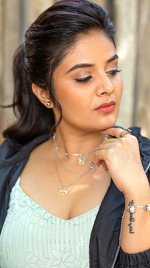 Sreemukhi in a mint lace top and black jacket with layered silver necklaces and a wrist tattoo HD phone wallpaper