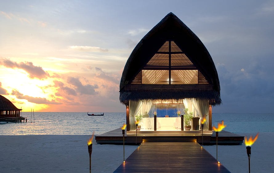 Luxury Maldives Overwater Bungalow at Sunset with Tiki Torches and Ocean View HD wallpaper