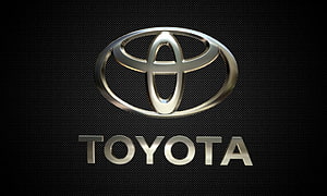Sleek Metallic Toyota Emblem on Dark Textured Background HD wallpaper