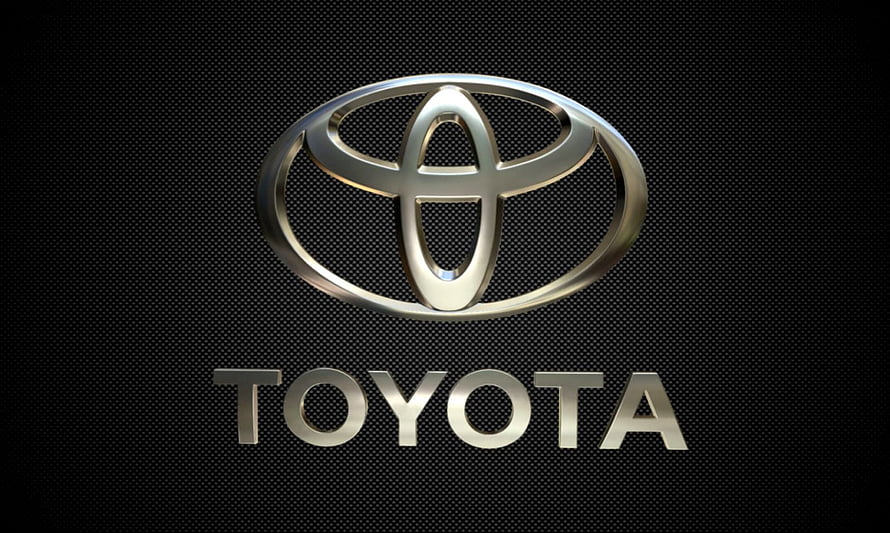 Sleek Metallic Toyota Emblem on Dark Textured Background HD wallpaper