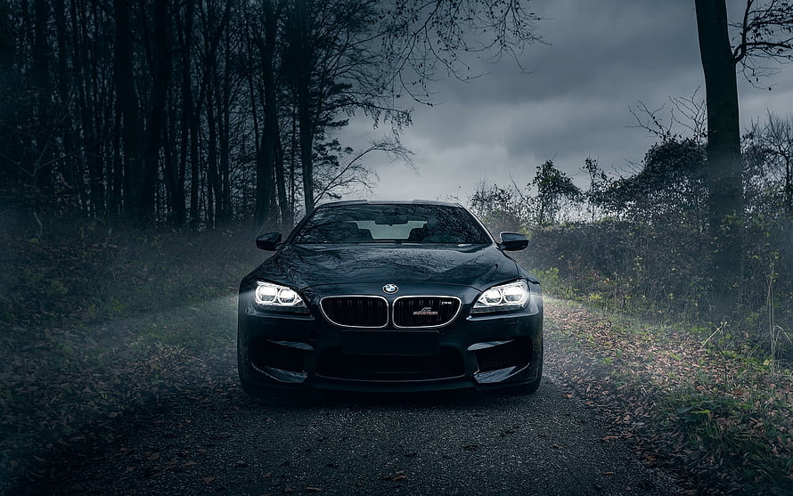 Black BMW M6 Coupe Front View on a Misty Forest Road HD wallpaper