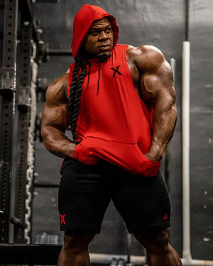 Kai Greene in Red Hoodie and Black Shorts at the Gym HD phone wallpaper