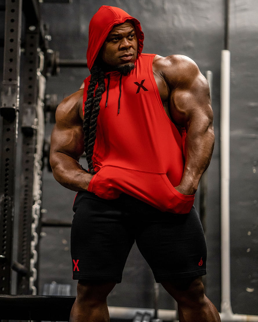 Kai Greene in Red Hoodie and Black Shorts at the Gym HD phone wallpaper