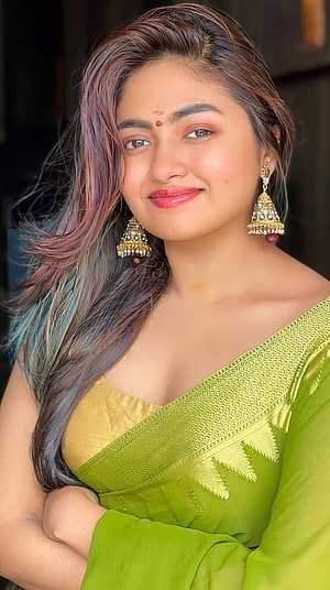 Young Woman in Green Silk Saree with Gold Jhumka Earrings and Multicolored Hair HD phone wallpaper