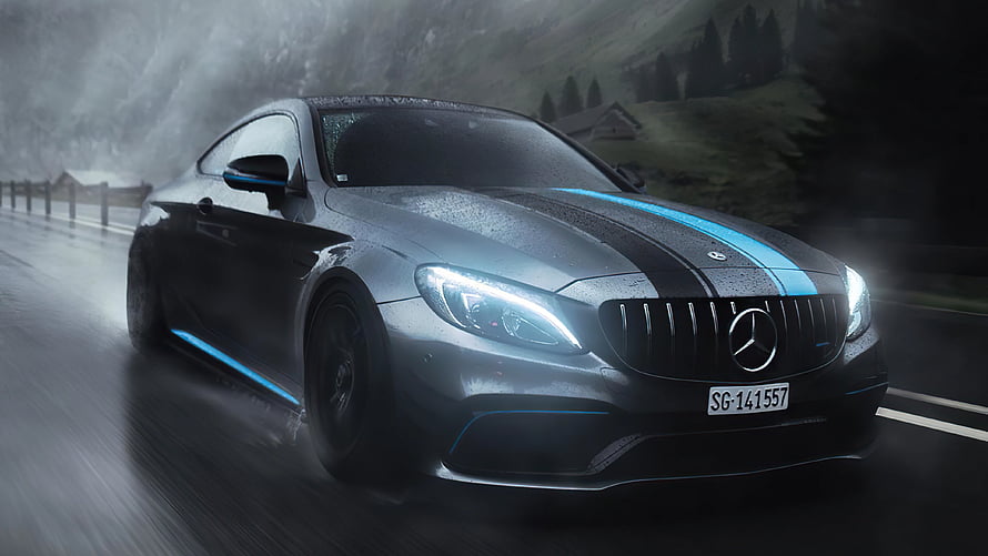 Mercedes-AMG C63 S Coupe with Blue Racing Stripes Driving on a Rainy Mountain Road HD wallpaper
