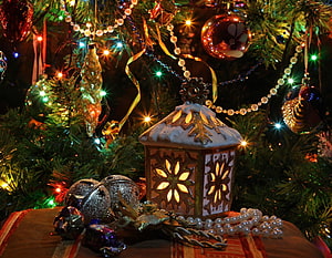 Festive Christmas Lantern with Snowflake Cutouts and Ornaments on a Decorated Tree HD wallpaper