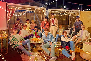 Seventeen K-Pop Group in Cozy Outdoor Setting with String Lights and Casual Fashion HD wallpaper