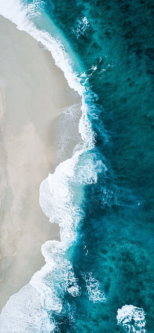 Aerial View of Turquoise Ocean Waves Crashing on White Sandy Beach HD phone wallpaper