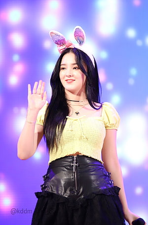 Nancy from MAMAMOO Waving in Yellow Top and Black Leather Skirt with Bunny Ears HD phone wallpaper