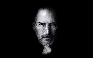 Steve Jobs Black and White Portrait with Round Glasses and Contemplative Expression HD wallpaper