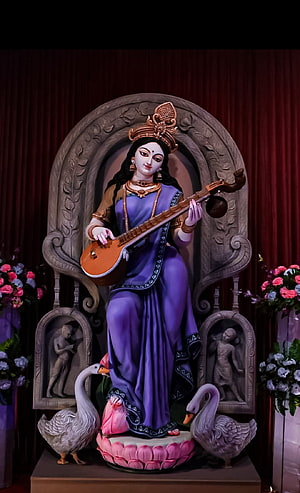 Goddess Saraswati Statue Playing Veena on Lotus Throne with Swans HD phone wallpaper