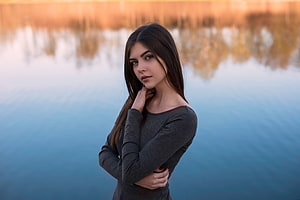 Serene Portrait of a Young Woman in a Grey Top Standing by a Calm Lake at Golden Hour, Cute, brunette, girl model, lake HD wallpaper