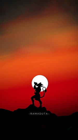 Ramaduta Hanuman Silhouette Standing on Rocky Peak Against Vibrant Sunset Sky HD phone wallpaper