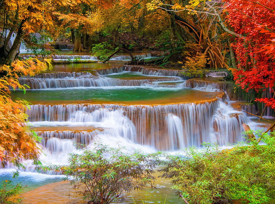 Vibrant Autumn Waterfall Cascade in a Lush Forest with Colorful Foliage HD wallpaper
