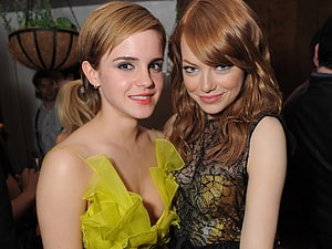 Emma Stone and Emma Watson posing together in elegant evening gowns at a social event HD wallpaper