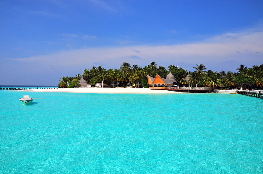 Tropical Island Resort in the Maldives with Turquoise Lagoon and Palm Trees HD wallpaper