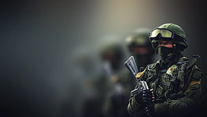 Russian Army Soldier in Camouflage Gear Holding Rifle in Smoky Battlefield HD wallpaper