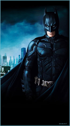 Batman in Dark Knight Rises Armor Standing Before Gotham City Skyline at Night HD phone wallpaper