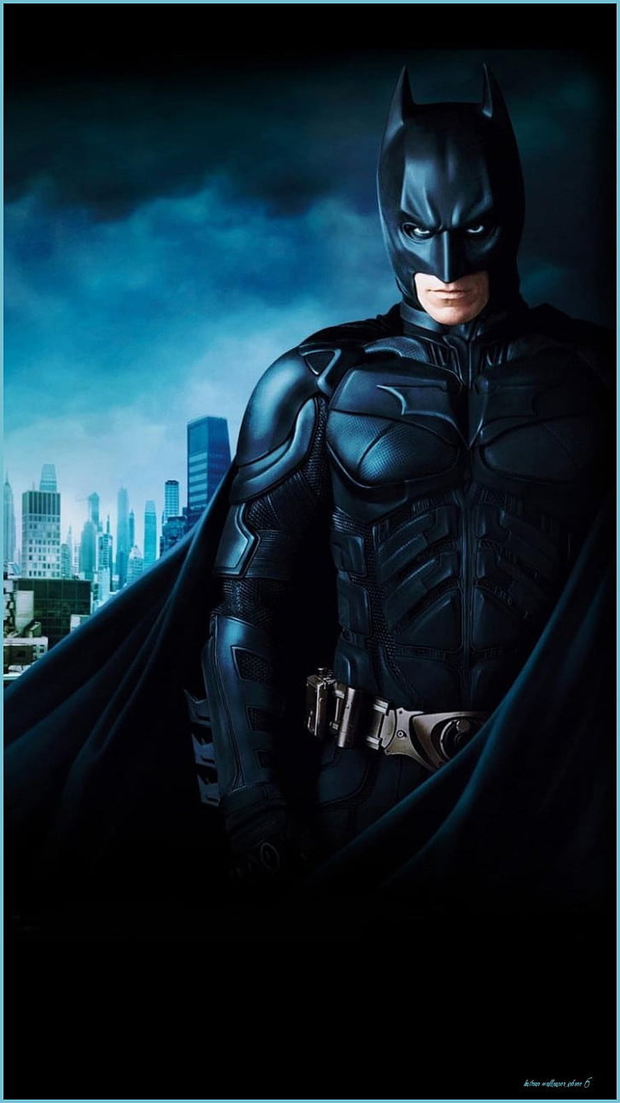 Batman in Dark Knight Rises Armor Standing Before Gotham City Skyline at Night HD phone wallpaper