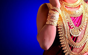 Elegant Indian Bride Adorned in Traditional Gold Jewelry and Pink Saree HD wallpaper