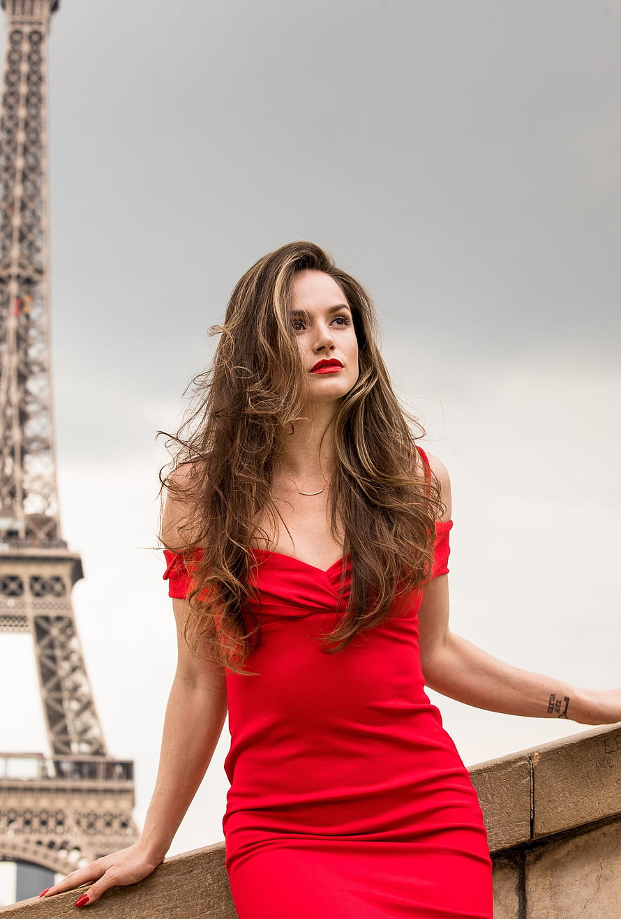 Elegant Woman in Red Dress Posing Against the Eiffel Tower in Paris HD phone wallpaper