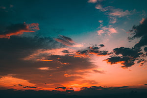 Dramatic Sunset Sky with Fiery Orange Clouds and Deep Teal Horizon HD wallpaper