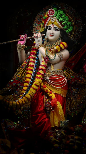 Ornate Krishna Murti Statue Playing Flute in Traditional Indian Temple Attire HD phone wallpaper