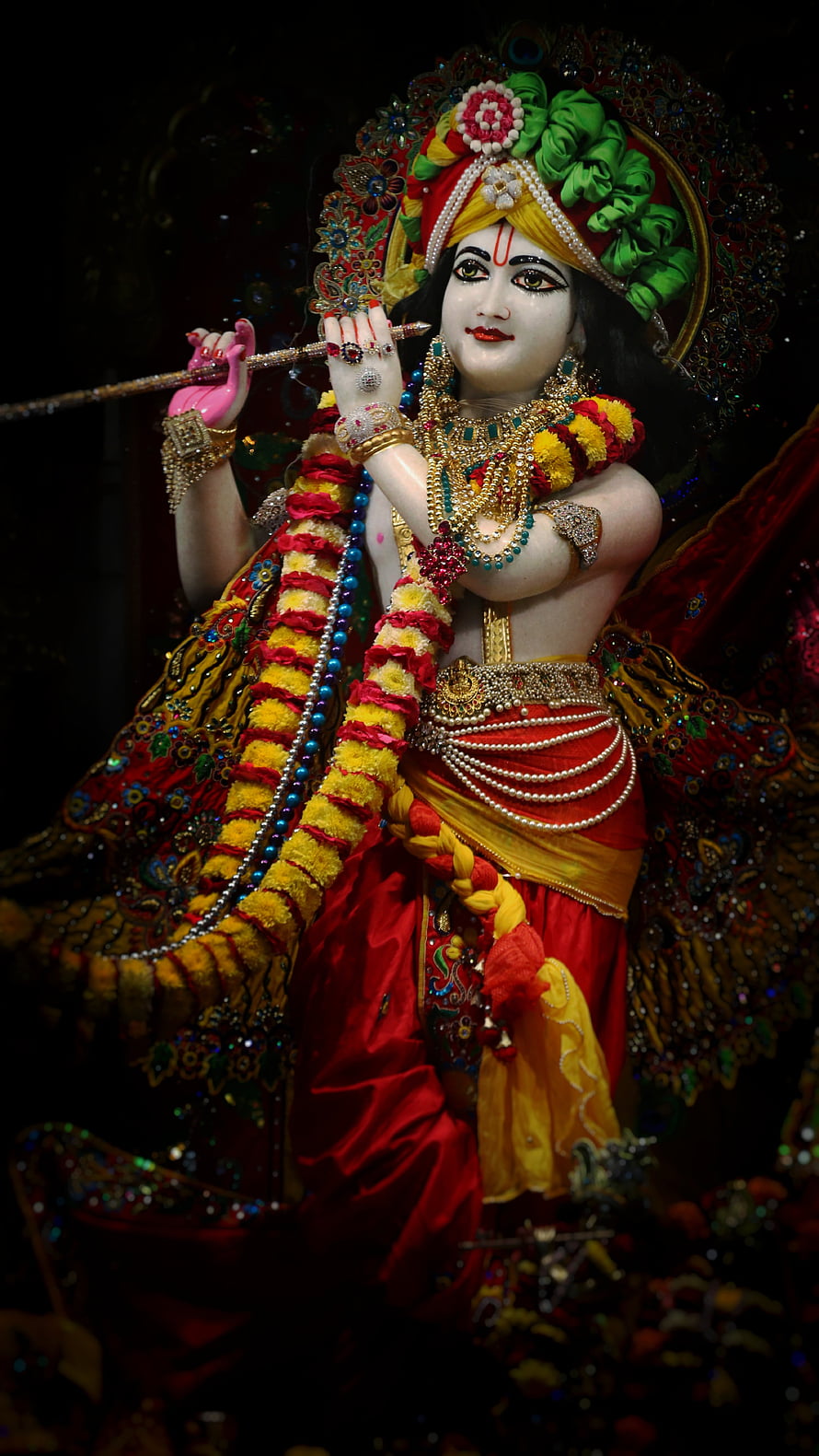 Ornate Krishna Murti Statue Playing Flute in Traditional Indian Temple Attire HD phone wallpaper