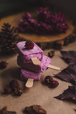 Rustic Purple Berry Popsicles Stacked with Fresh Blackberries and Pinecones HD phone wallpaper