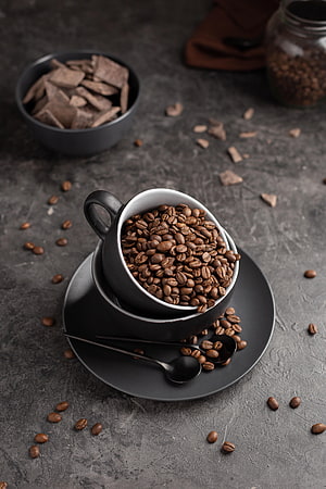 Dark Coffee Beans in Black Cup with Chocolate Shards on Slate Surface HD phone wallpaper
