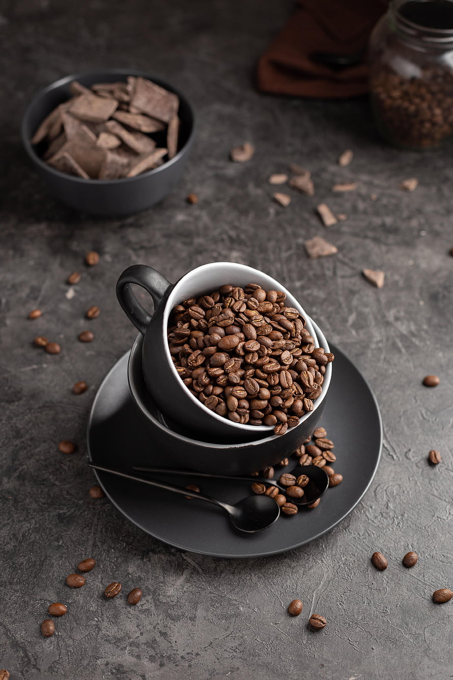 Dark Coffee Beans in Black Cup with Chocolate Shards on Slate Surface HD phone wallpaper