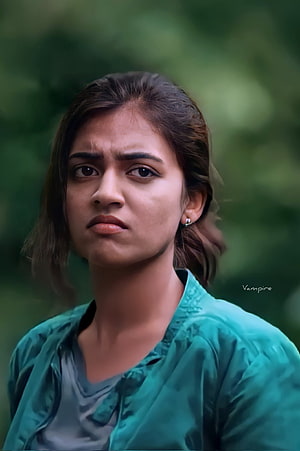 Nazriya Nazim Portrait in Teal Shirt Against Blurred Green Background HD phone wallpaper