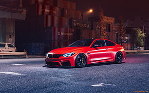 Red BMW M4 Coupe Parked on Urban Street at Night with Shipping Containers HD wallpaper