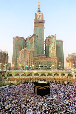 Massive Pilgrimage Gathering at the Kaaba in Mecca with Clock Tower Rising Above HD phone wallpaper