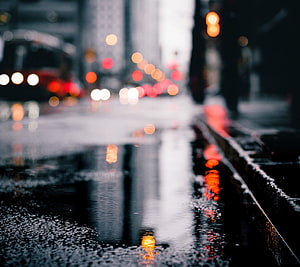 Moody Urban Street Scene with Rain Reflections and Bokeh City Lights HD wallpaper