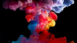 Vibrant multicolored ink clouds swirling in water against a dark background HD wallpaper