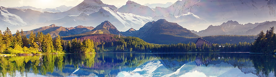 Alpine Lake Reflections with Snow-Capped Peaks and Forested Shores HD wallpaper