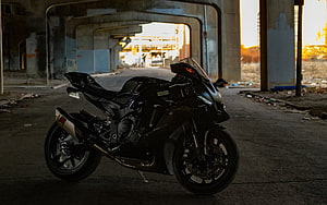 Black Yamaha YZF-R1 Sportbike Parked in Concrete Underpass at Golden Hour HD wallpaper